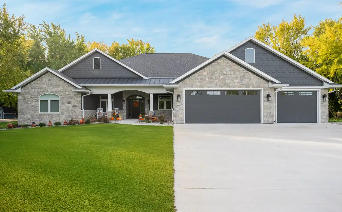 Front view of custom home with stone and siding.